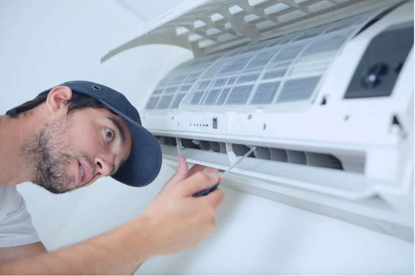 Engineer repairing air conditioning unit